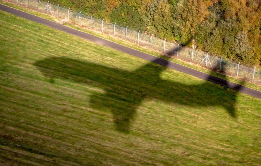 The shadow of a commercial jet as it comes in to land at Edinburgh Airport, Scotland.